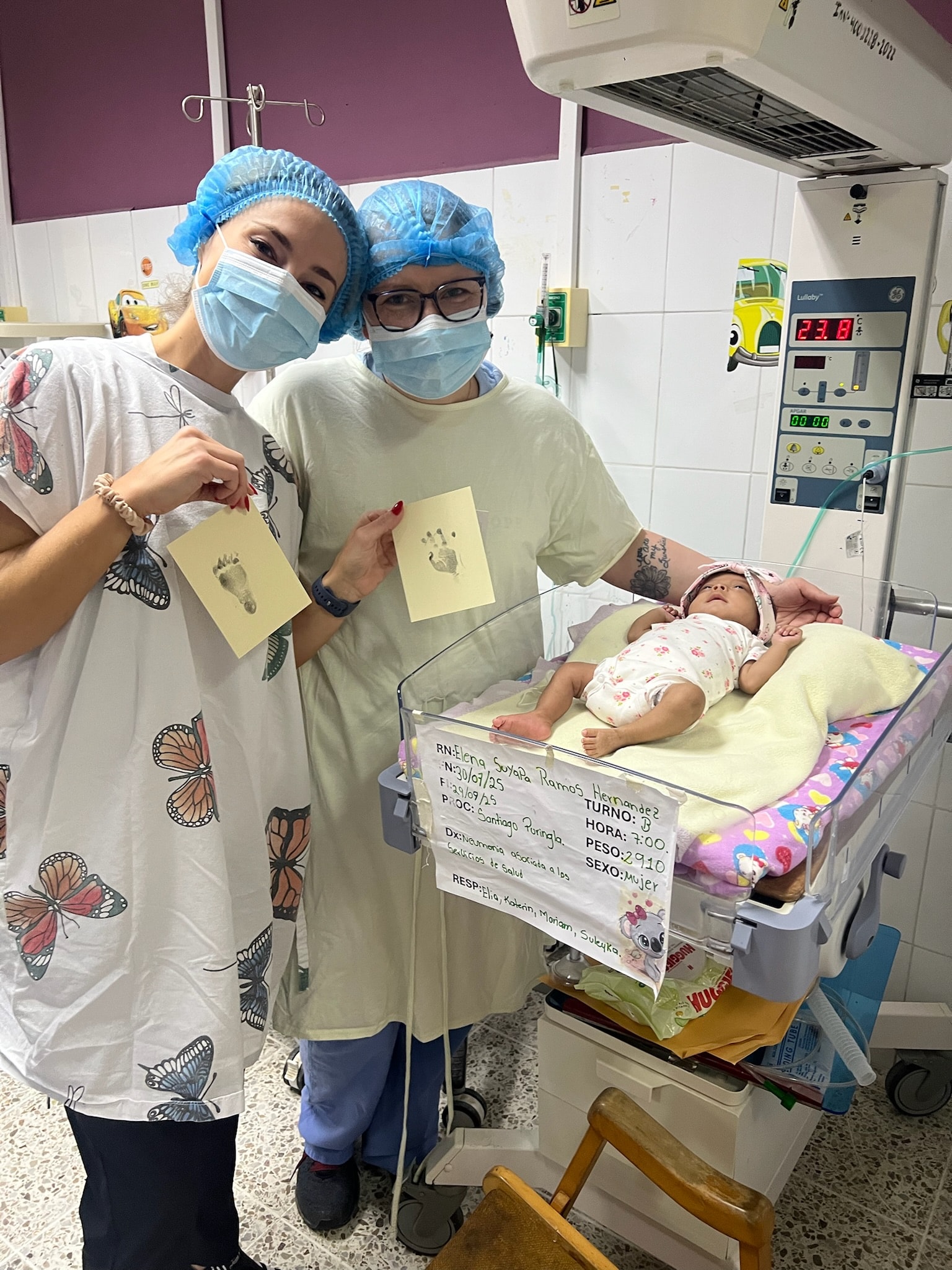 Healthcare workers holding newborn footprints at the hospital