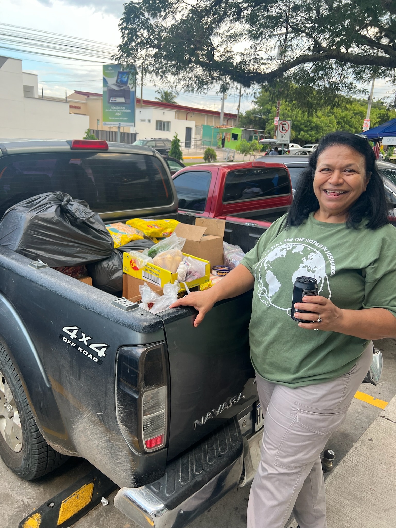 Woman smiling with a truck full of groceries