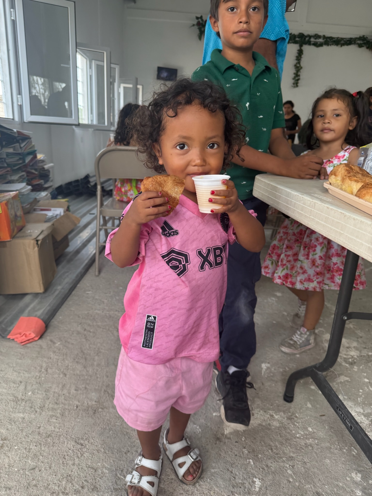 Toddler eating a snack at a community gathering