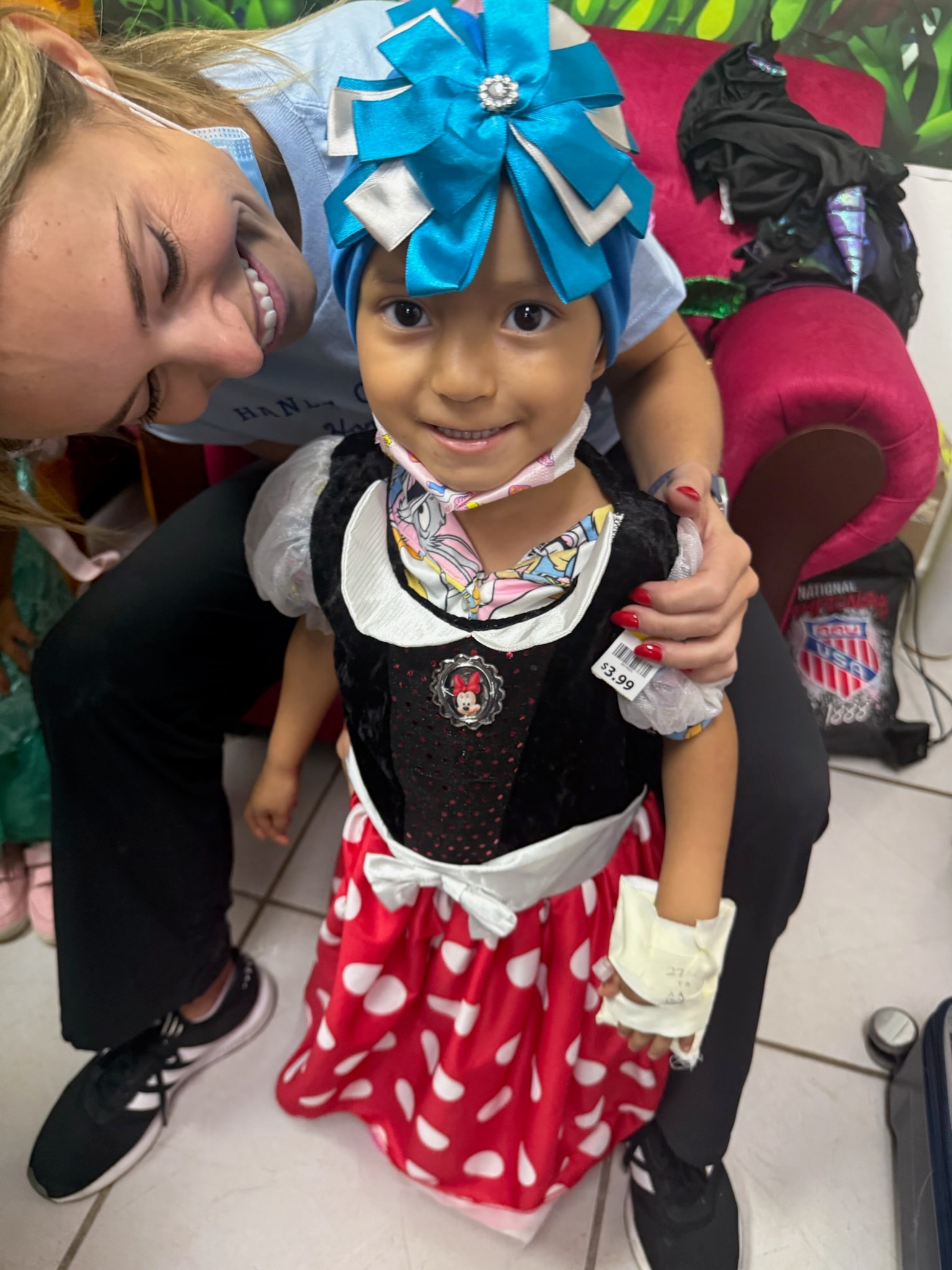 A young girl in a festive costume, smiling